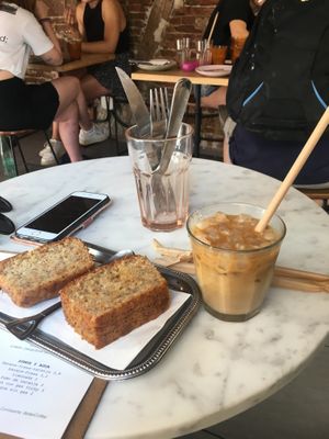 Banana loaf and oat iced latte   at Plantate Cafe in Madrid