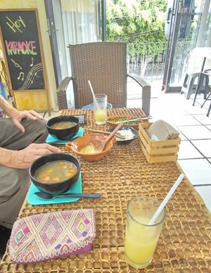 Lentil/veggie soup with fresh onions, cilantro and spicy salsa 😋 at La Garnacheria Vegana in Cuernavaca