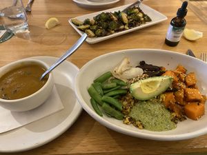 Ancient grain bowl and half order butternut squash soup. Brussel sprouts in the background   at True Food Kitchen in The Woodlands
