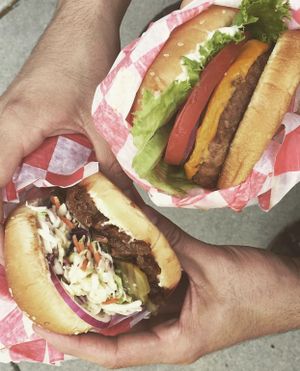 Vegan Burgers! On the left is the Vegan BBQ Sandwich with coleslaw and on the right is one of our classic Vegan Cheeseburgers! at DeVine Delights in Rapid City