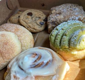 Treat box with almond coffee cake, banana chocolate chip cookies, matcha concha, cinnamon roll, and a Salvadoran sweet bread  at Baked Vegan in Port Chester