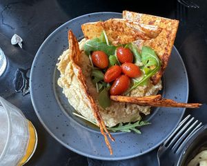 Hummus with spiced pita, arugula and grilled grape tomatoes   at Korova in Athens