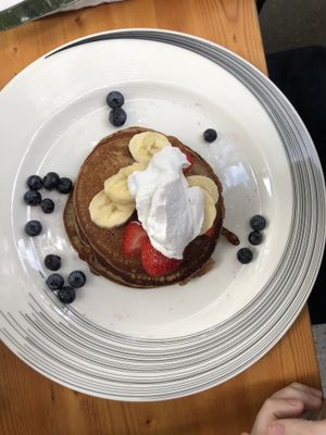 Pancakes with banana, berries and coconut cream at Blossom Restaurant on Columbus in New York City