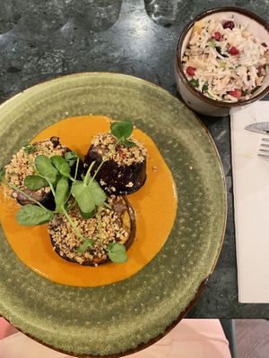 Aubergine Massala (roasted eggplant with cashew nuts on top, tikka masala sauce and biryani rice with pomegranate as a side dish)  at Waku Waku in Utrecht