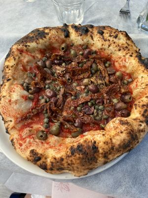 Vegan sun-dried tomato, olive, and caper marinara pizza   at Il Ruttino in Sorrento