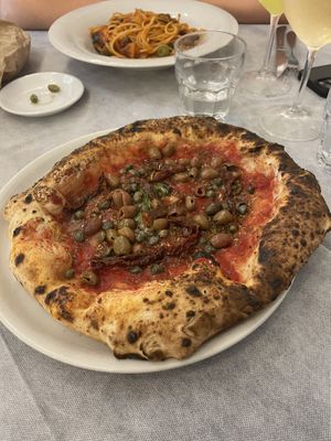 Vegan pizza with olives, sun dried tomatoes and capers. Vegan pasta with tomatoes,olives, courgette and peppers   at Il Ruttino in Sorrento