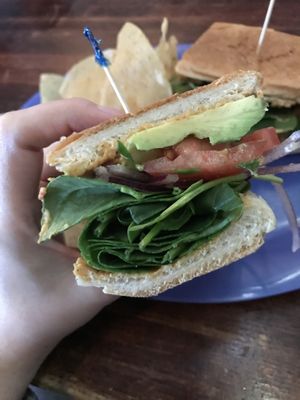 Hummus, avocado, tomato, onions and spinach. Good bread!  at Cherrywood Coffeehouse in Austin