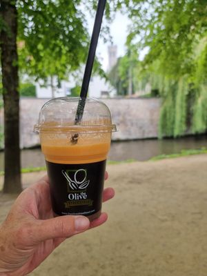 Fresh juice, belfry in background at The Olive Street Food  in Bruges