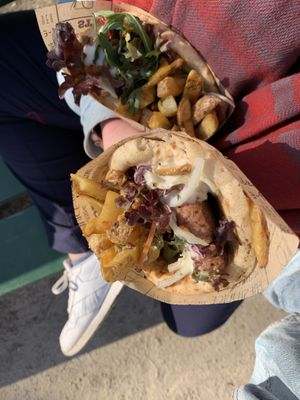 Top is veggie pita, bottom is burger pita. Both come with greens and fries.  at The Olive Street Food  in Bruges