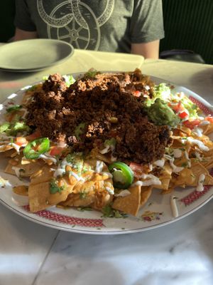 Amazing nachos. We added the chorizo and guacamole. This is the large size.   at Rosalinda in Toronto