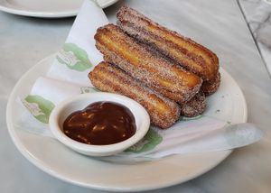Churros with banana chocolate caramel sauce. at Rosalinda in Toronto
