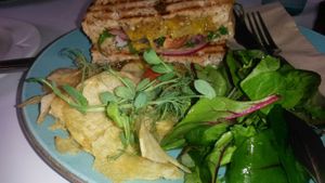 Onion bhaji super sandwich with mango and tomato chutney and sides  at Hive Coffee Company in Jarrow