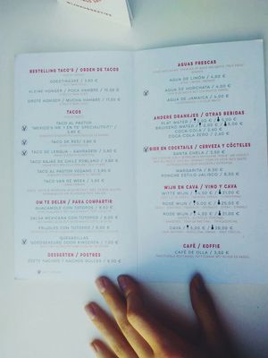 Menu, mentioning which options are not vegan ;) at Taco Santo in Ghent