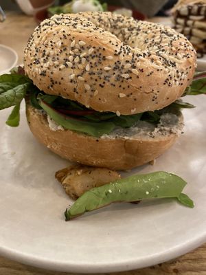 Bagel with vegan ricotta, heura chikn and ruccola  at Religion Coffee in Madrid