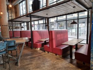 Seatings at window, looking at Central station at BrewDog in Brussels