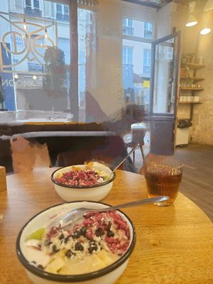 Pink granola, seasonal fruit,  coconut yoghurt topped with almond butter at Wild & The Moon - Amelot in Paris