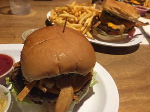6 layer Impossible Burger =  avocado, tomato, lettuce, tortilla strips, soy chicken strips, aioli  at Strummer's in Fresno