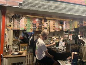 Inside - a table for two and 4 bar seats at Sushi Roll Double Quotation IKI in Osaka