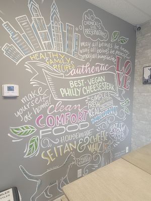 Inside art wall decor at Dina's Vegan Deli & Desserts in West Palm Beach