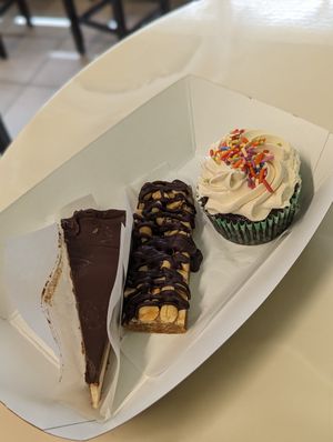 Cheesecake, Snickers, Peanut Butter Frosted Cupcake at Dina's Vegan Deli & Desserts in West Palm Beach