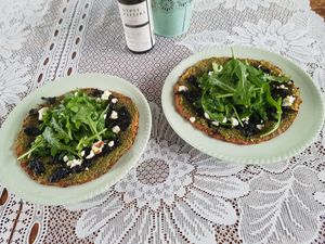 cauliflower pizza topped with pesto, onion jam and tetra with a dressed rocket salad at Jarra Infusion in Pinjarra