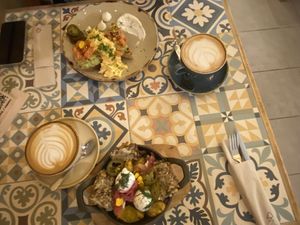 At the right, the guacascramble toast and chai latte with oat milk  at EatMyTrip  in Barcelona