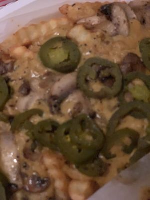 Cheese fries added jalapeños and sautéed mushrooms  at Trilly Cheesesteaks in New Orleans