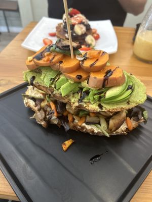 Vegan toast - hummus, avocado, roasted veg, and sweet potato    at Cheese and Cake in Barcelona