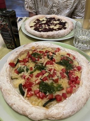 At the back vegan blue cheese, front the pesto. Dough very tough .   at La Pepiniere in Florence