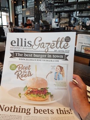 Advertising for their vegan burger on their own gazette at Ellis Gourmet Burger in Leuven