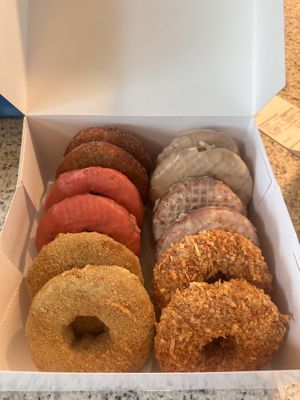 From back to front, left to right: cinnamon, cherry, key lime, maple, lemon, coconut donuts   at The Holy Donut - Commercial St in Portland