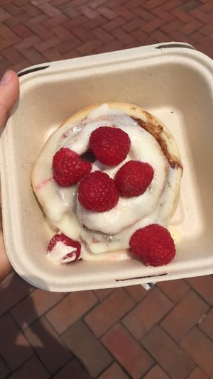 Cinnamon roll with cream cheese frosting and raspberries.   at Cinnaholic in Baltimore