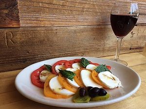 Zachary’s Caprese Salad! Made with heirloom tomato, fresh mozzarella, dressed with olive oil, aged balsamic vinegar and garnished with fresh basil & kalamata olives! at Zachary's Chicago Pizza in San Ramon