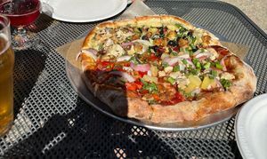 Pizza flight. 4 different pizzas in one. We chose pesto chickun, aloha BBQ, curse of the goat, and Mediterranean. Pesto was our favorite! HIGHLY RECOMMEND   at The Mitten Brewing Company in Saugatuck