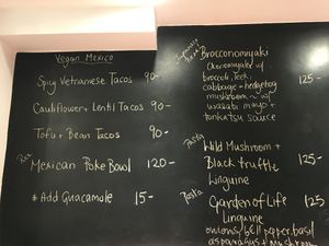 Menu on the wall  at Confusion Plant Based Kitchen in Hong Kong Island