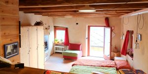 East room.
3 large independent rooms, each with an en-suite bathroom, kitchen area and terrace. at Casa Payer in Luserna San Giovanni