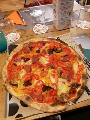 Vegan pizza with cheese and fake meats at Yolo Pizza in Valencia