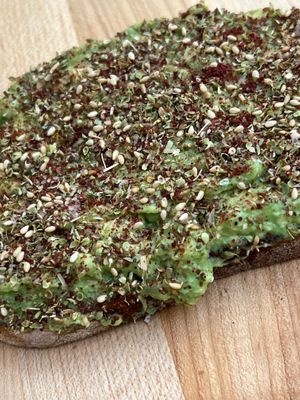 Delicious Avocado Toast. Loads of avocado on sourdough bread (or GF toast), topped with Aharon's homemade za'atar (oregano, sumac, and toasted sesame seeds) and Himalayan sea salt. at Aharon Coffee in Beverly Hills