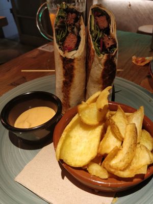 Burger wrap and potatoes with bravas sauce at Amarre 69 in Barcelona