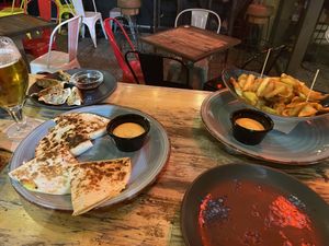 Quesadilla con carne, gyozas and patatas bravas 69  at Amarre 69 in Barcelona