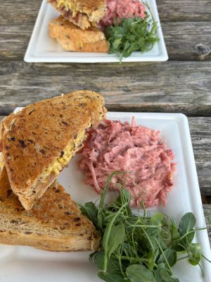 Vegan cheese and red onion marmalade toasties on granary bread, with homemade vegan coleslaw and micro greens. at Peak Feast in Bakewell