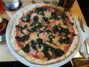 Vegan pizza with spinach at Manso Pizzeria in Barcelona