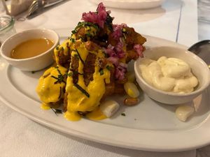 Fried and Breaded Fish with Yellow Sauce at Los Andenes Vegan in Madrid