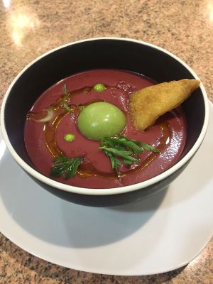 Sopa de remolacha con esfera de aguacate at Los Andenes Vegan in Madrid
