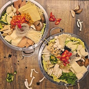 Odeng Yachae Jeongol and Budae Jeongol, loaded with fresh vegetables, silky tofu, mushrooms and dumplings in savoury, deep-tasting broths at Daehwa Vegetarian in Central Singapore