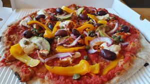 Avocado Onion Olive Caper Pepper Pizza with Vegan Cheese at Stripped Pizza - Talacker in Zurich