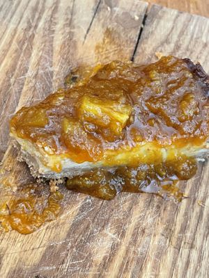 The delicious cheesecake. We never ate something closer to this. The pineapple jam on top, the middle part is creamy and not too sweet and the crunchy cookie is on top! 🤤  at SOIL Vegan Cafe - West in Amsterdam