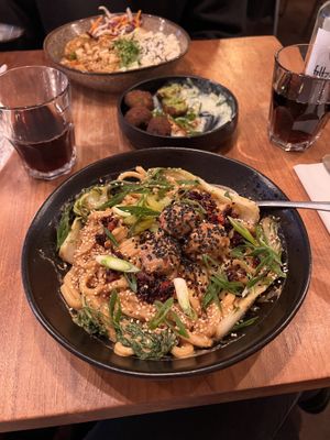 „Ben Ben Noodles“ creamy sesame sauce with udon noodles, meatballs, pak soy, crispy chili oil, scallions and pickles - spicy!!  at SOIL Vegan Cafe - West in Amsterdam