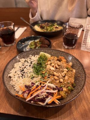 Peanut Butter Curry with smoked tofu. carrots. peas. broken beans. flcgeolets, furnip, siaw, peanuts, conander and rice  at SOIL Vegan Cafe - West in Amsterdam