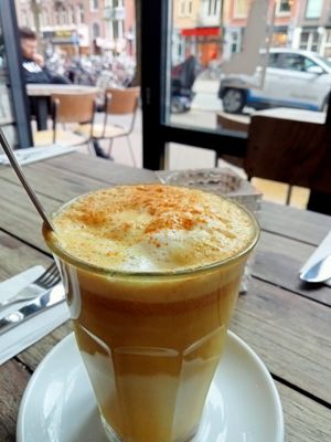 Turmeric golden latte with almond milk at SOIL Vegan Cafe - West in Amsterdam